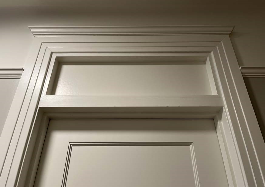 Salvaged historic doors, restored transom 